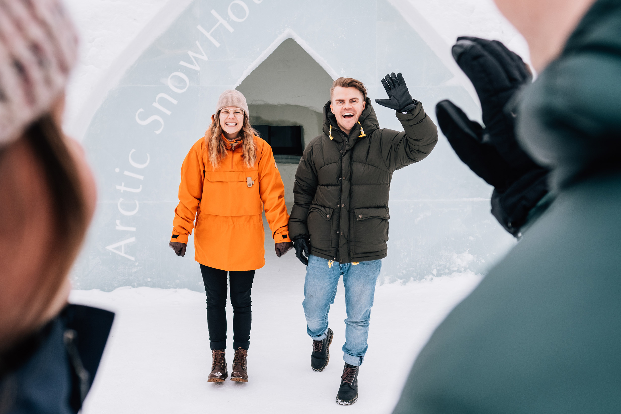 Two visitors in front of Arctic Snowhotel entrance