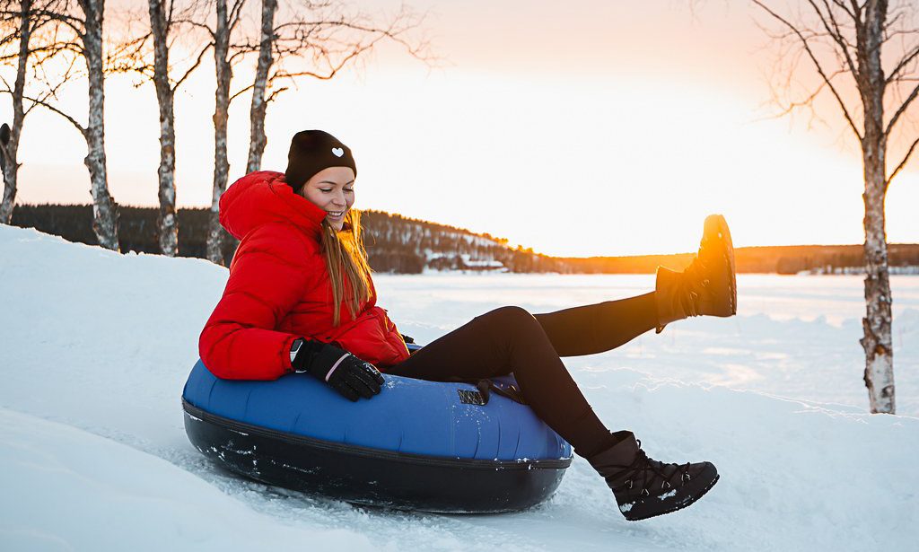 A woman on a snow toboggan