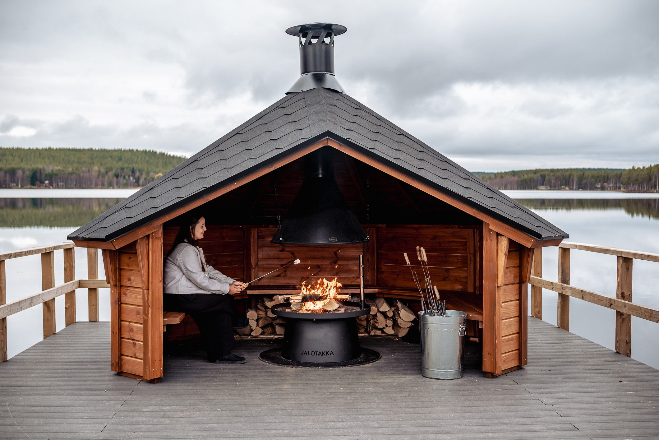 Things to do in Rovaniemi: roasting marshmallows in floating lean-to