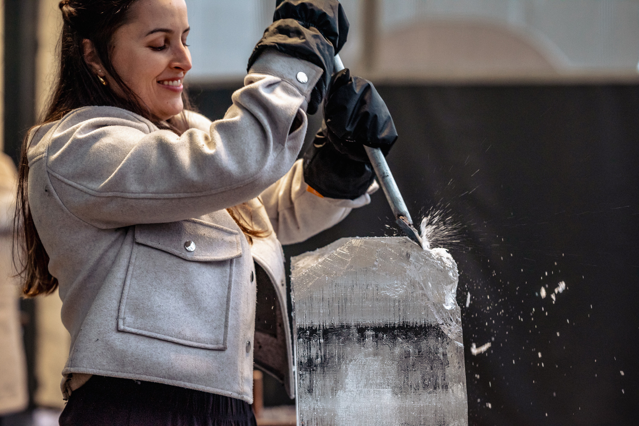 A woman sculpting an ice cube