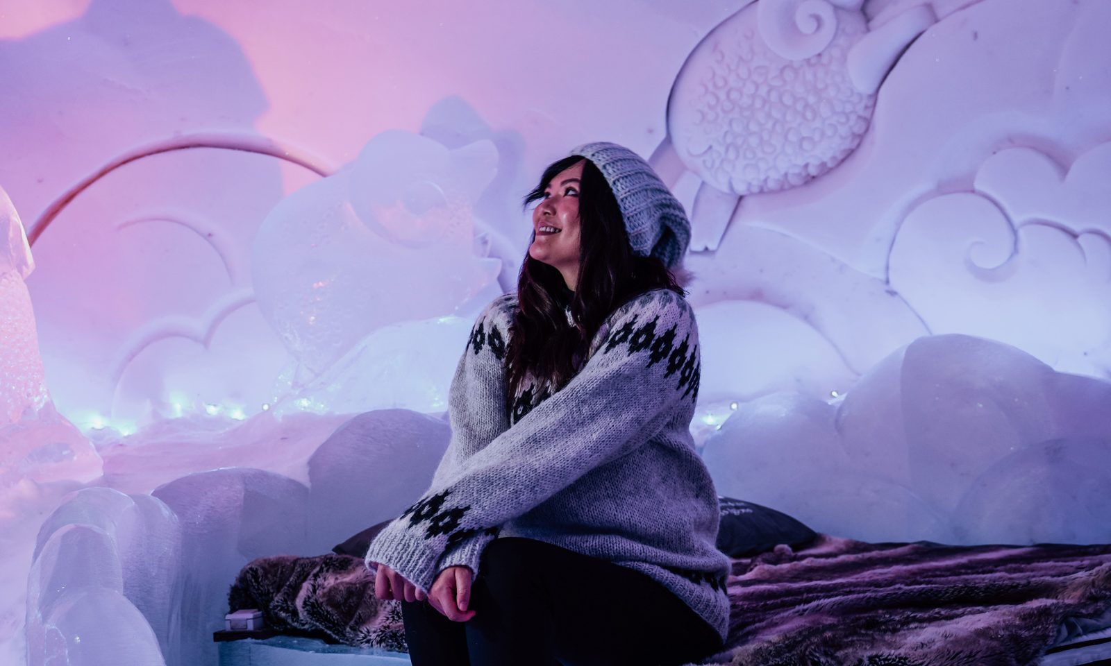 Nainen vierailee lumi- ja jäähotellissa ja ihailee lumitaidetta