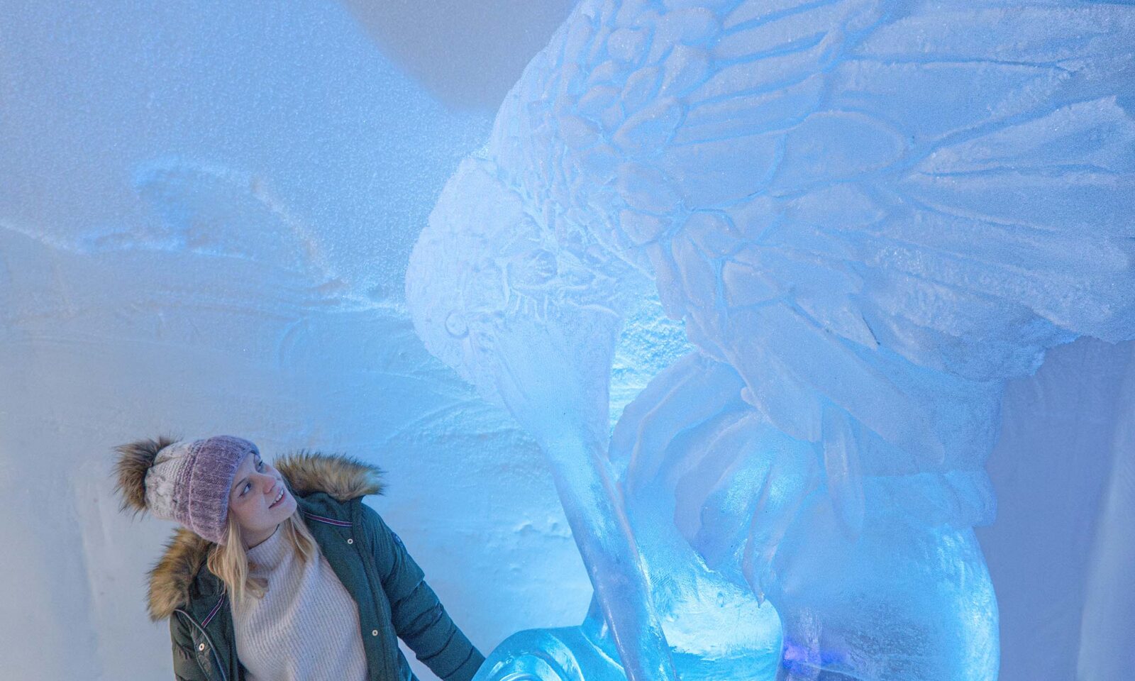 Visitor admiring ice art in the ice hotel