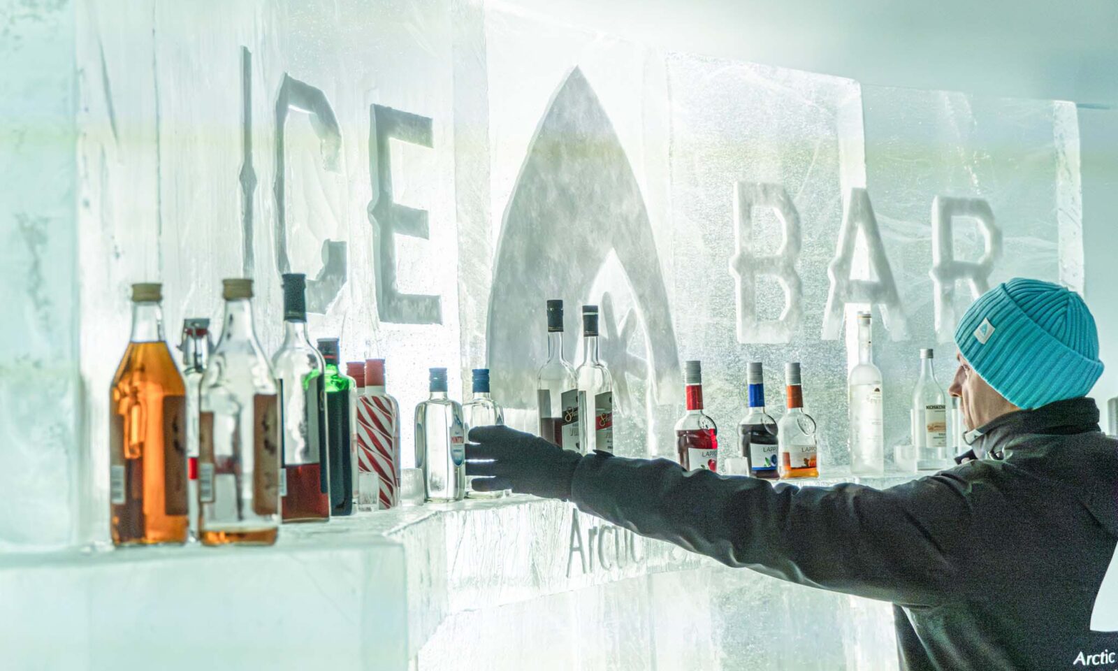A waiter picks up a bottle for the ice counter.
