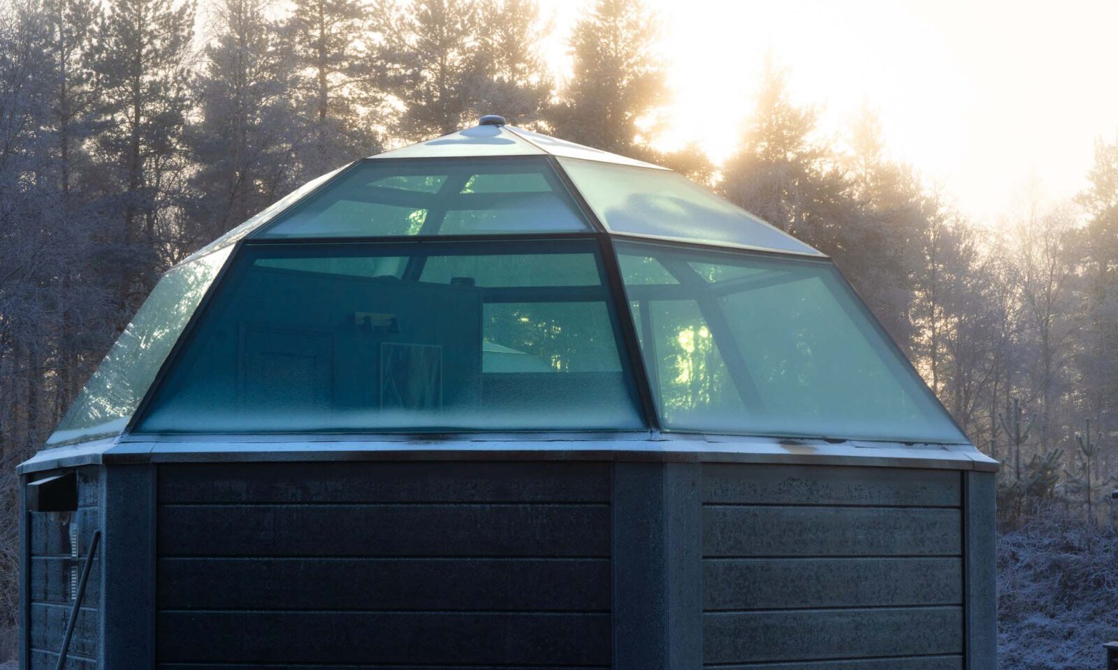 Glass igloo in early winter landscape