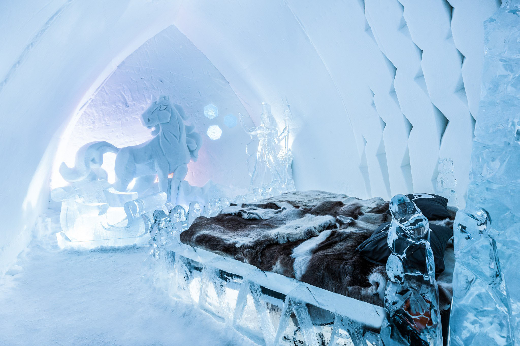 Snow and ice hotel suite with art decor.